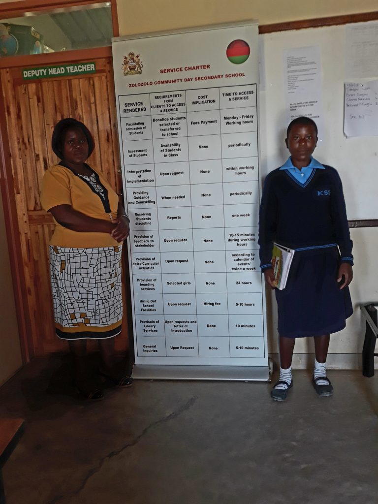 Virginia Soko at Zolozolo Secondary School posing a photo with the Head teacher. Says, I can see light in my future.